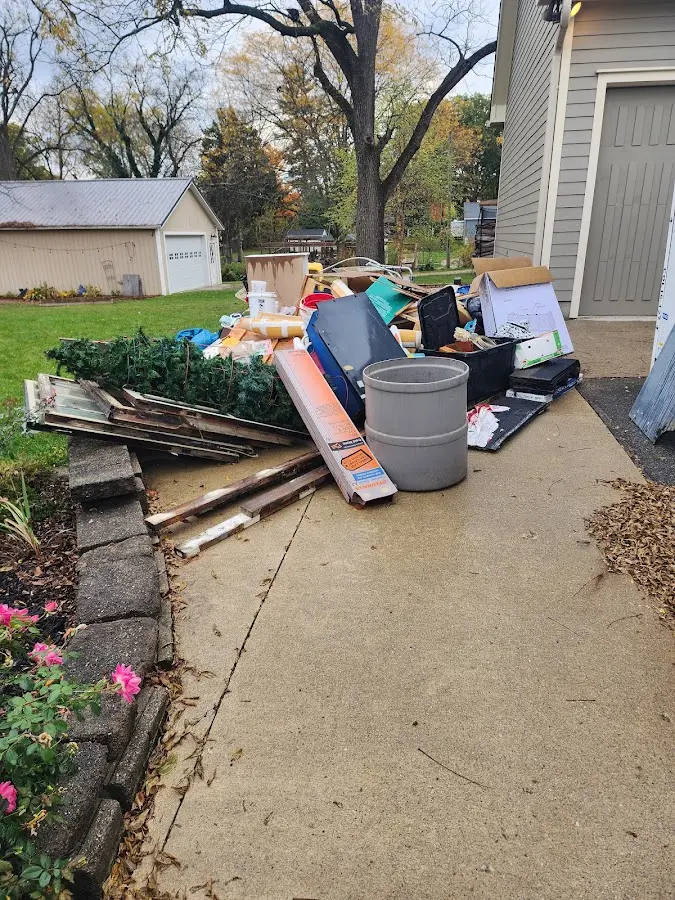 Dumpster being loaded with debris for Estate Cleanout Dumpster Rental in New Britain